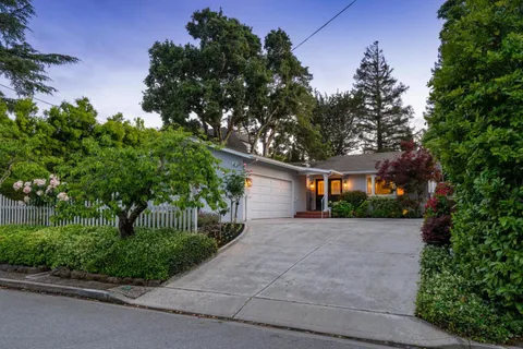 a front view of a house with a yard and a garage