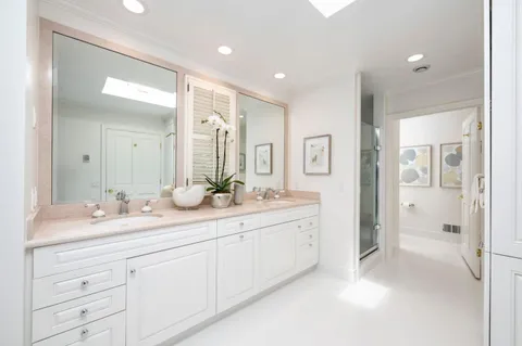 a spacious bathroom with double sink and a mirror