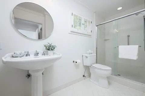 a bathroom with a sink toilet and a mirror