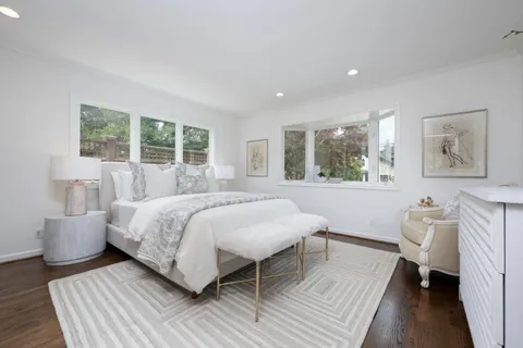 a bed room with a bed and a chair