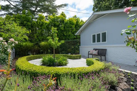 a view of a backyard with sitting area