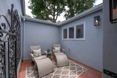 a front view of a house with outdoor seating