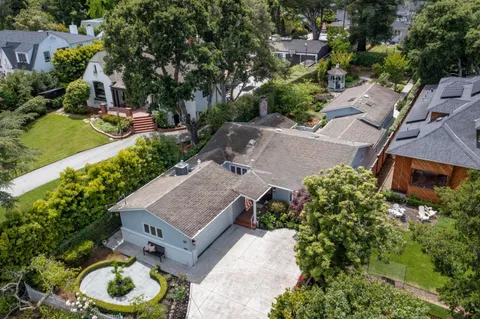 an aerial view of a house with garden space and street view