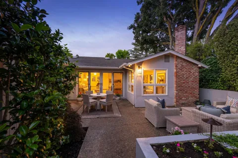 a backyard of a house with yard barbeque oven and outdoor seating