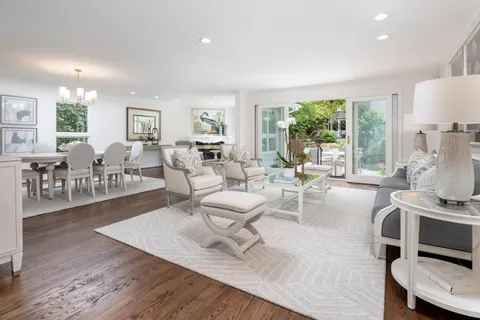 a living room with furniture a large window and a table