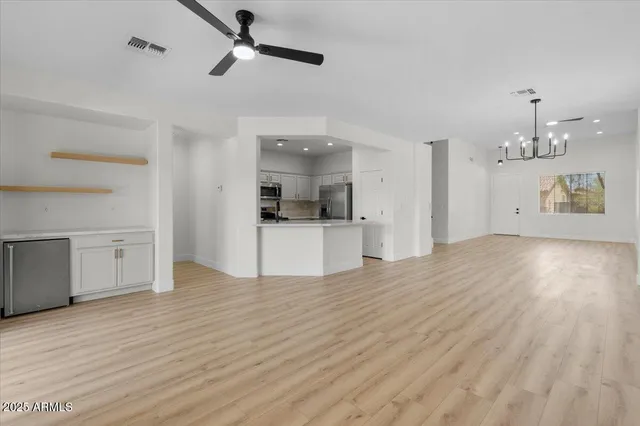 a view of a kitchen with a sink and a refrigerator