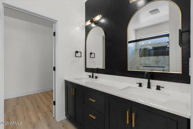 a bathroom with a double vanity sink and a mirror
