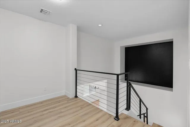 a view of a room with wooden floor and wardrobe