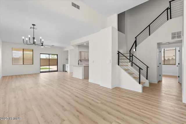 a view of empty room with wooden floor and window