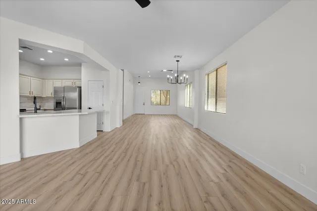 a view of kitchen and hall with wooden floor