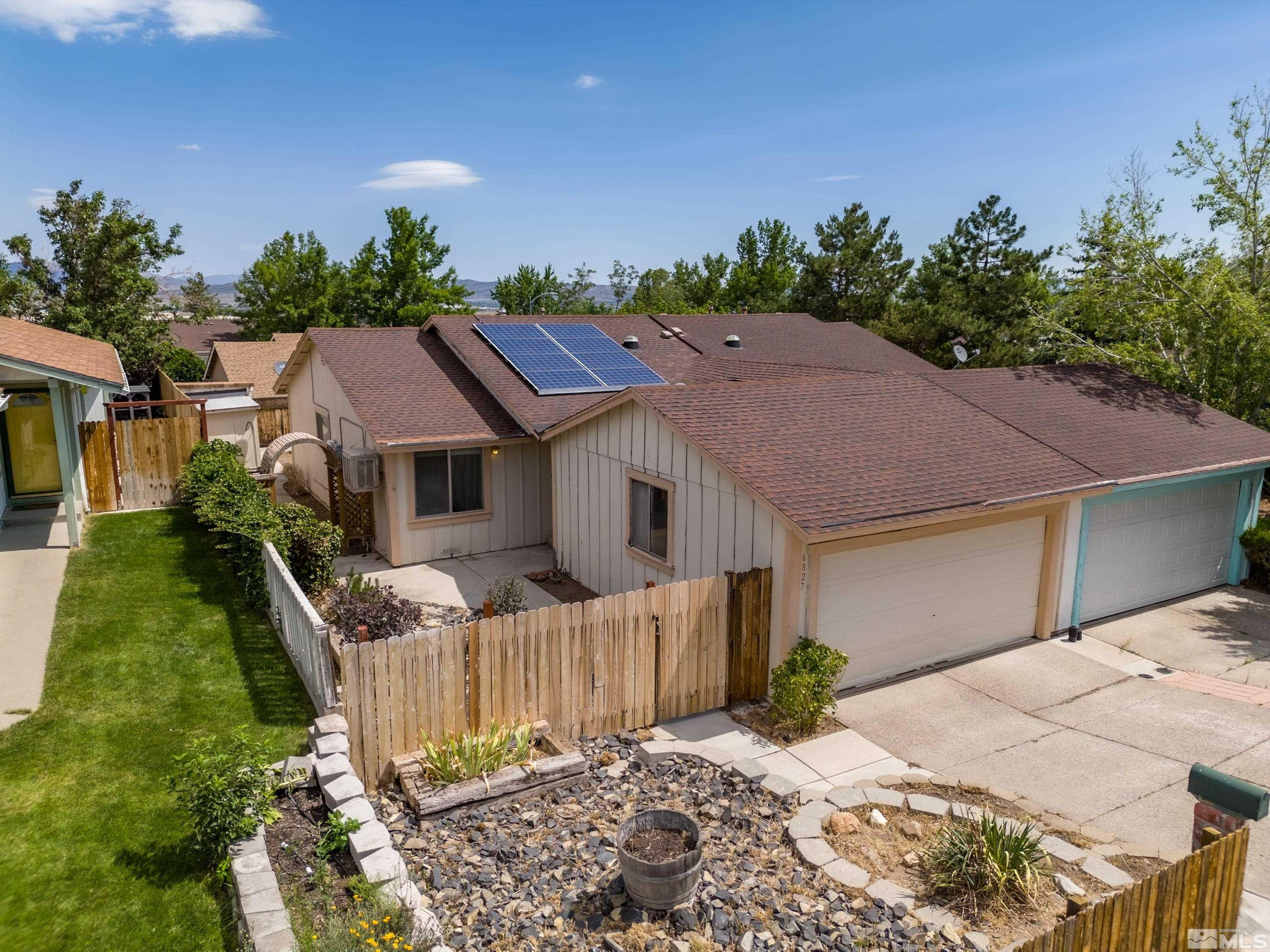 6827 Flower Street Reno, NV 89506 - Photo 1 of 31 a house with trees in the background