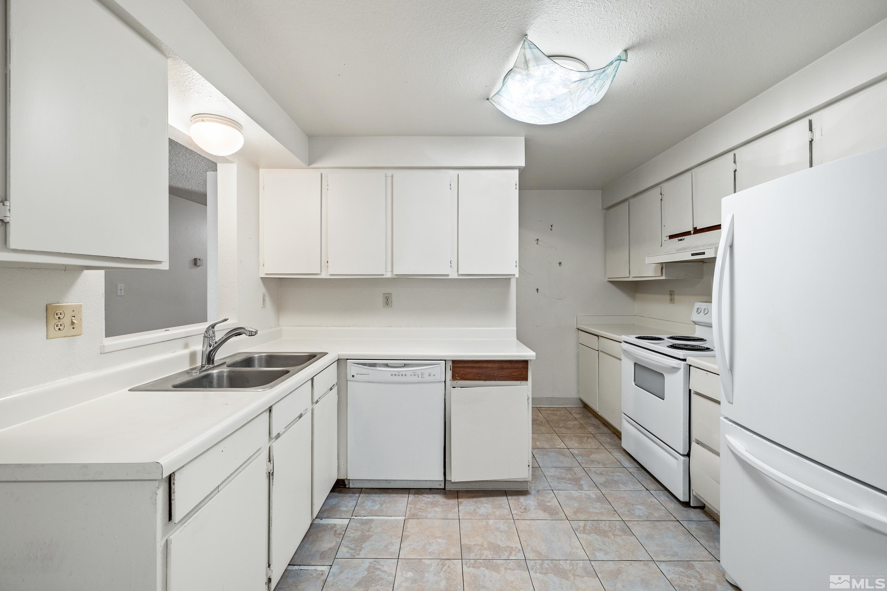6827 Flower Street Reno, NV 89506 - Photo 11 of 31 a kitchen with a sink cabinets and window