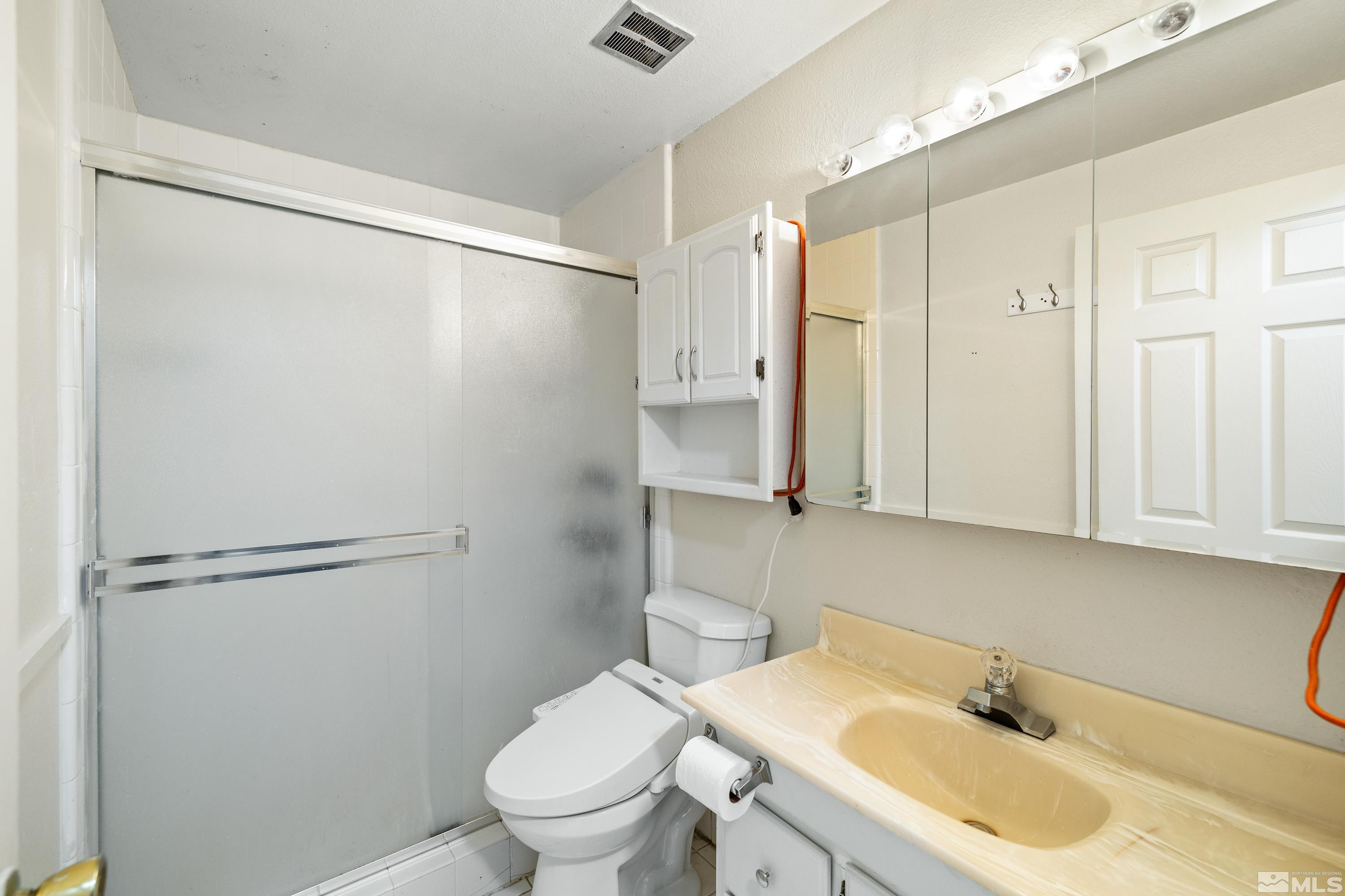 6827 Flower Street Reno, NV 89506 - Photo 17 of 31 a bathroom with a sink toilet and shower