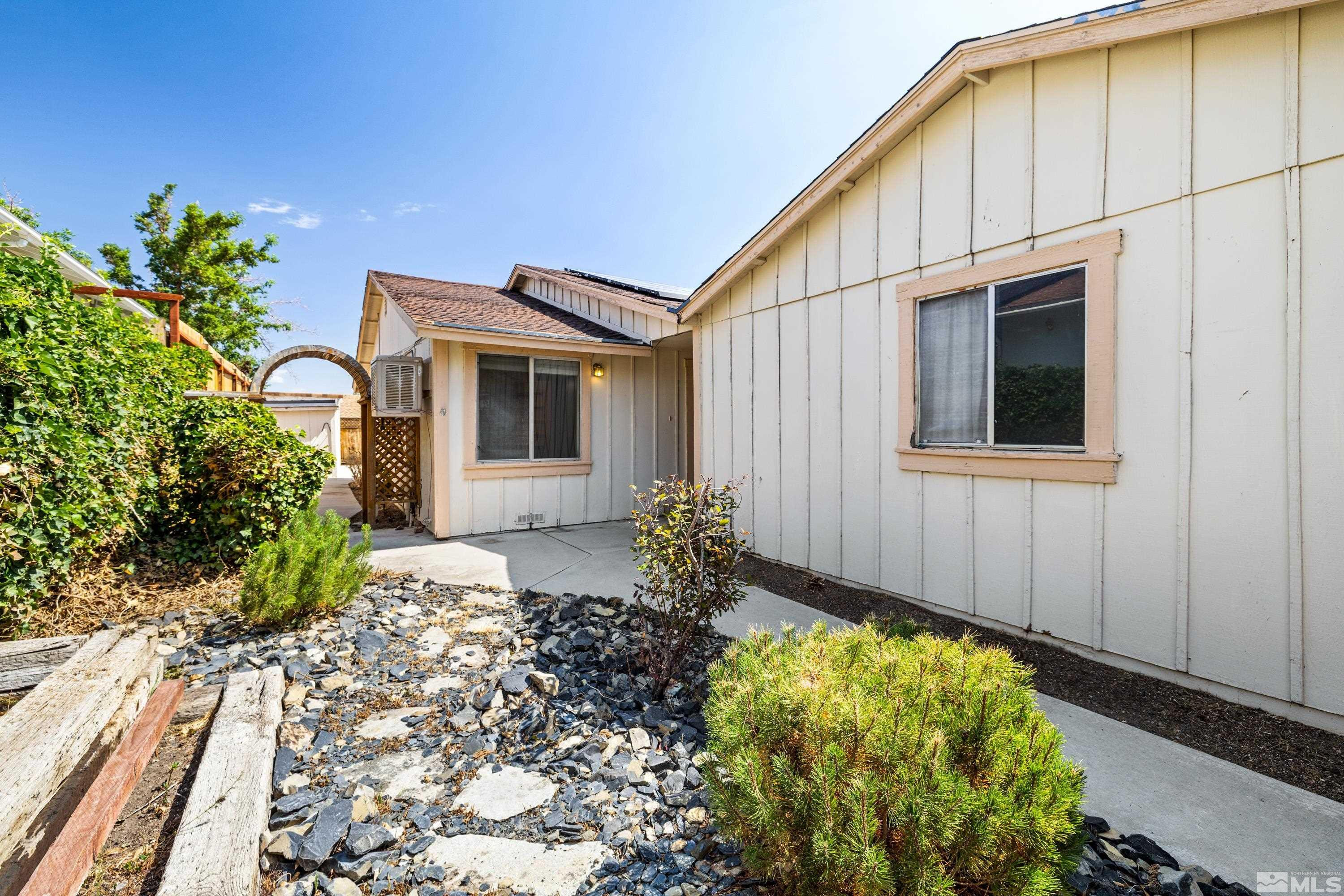 6827 Flower Street Reno, NV 89506 - Photo 2 of 31 a front view of a house with garden