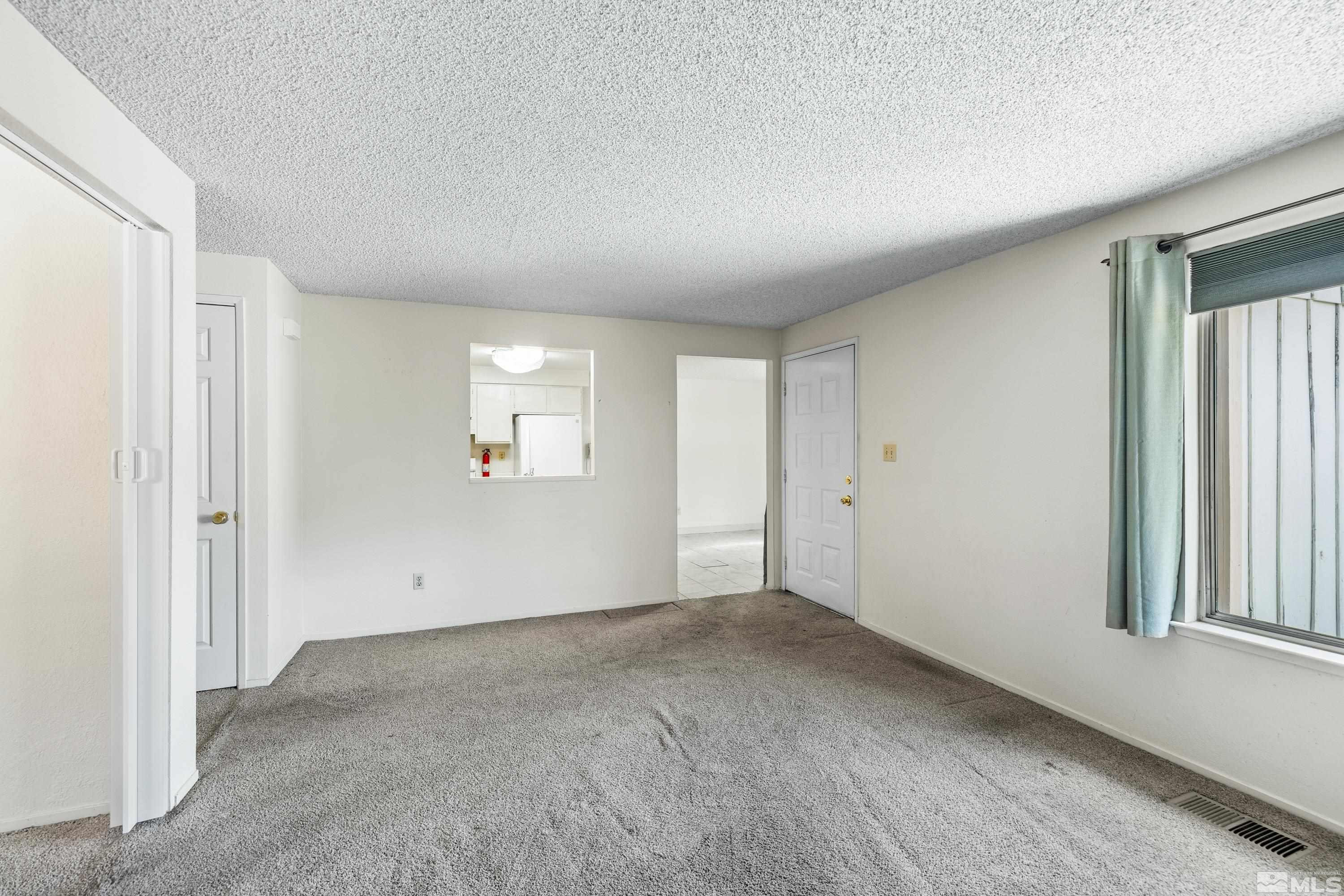 6827 Flower Street Reno, NV 89506 - Photo 9 of 31 a view of an empty room with a window