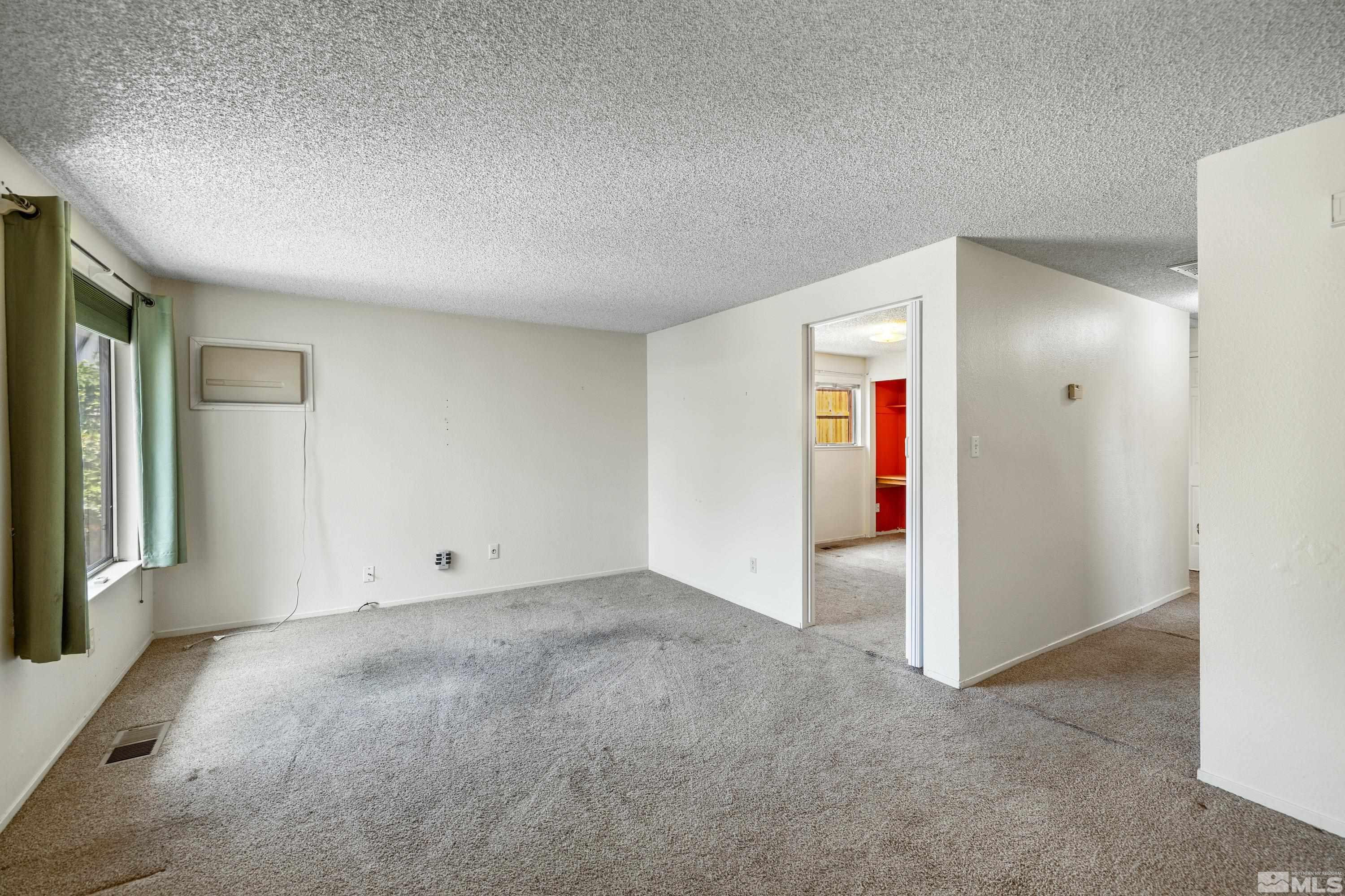 6827 Flower Street Reno, NV 89506 - Photo 10 of 31 an empty room with window and hallway
