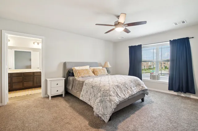 a bed room with a bed and a window