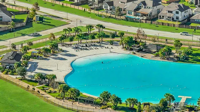 an aerial view of a house with a garden and swimming pool