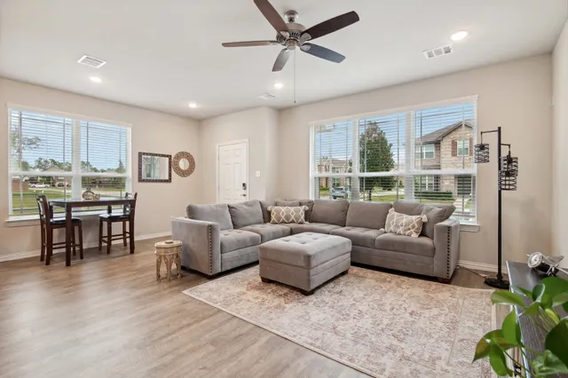 a living room with furniture and a large window