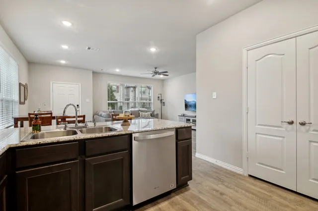 a kitchen with sink cabinets and wooden floor
