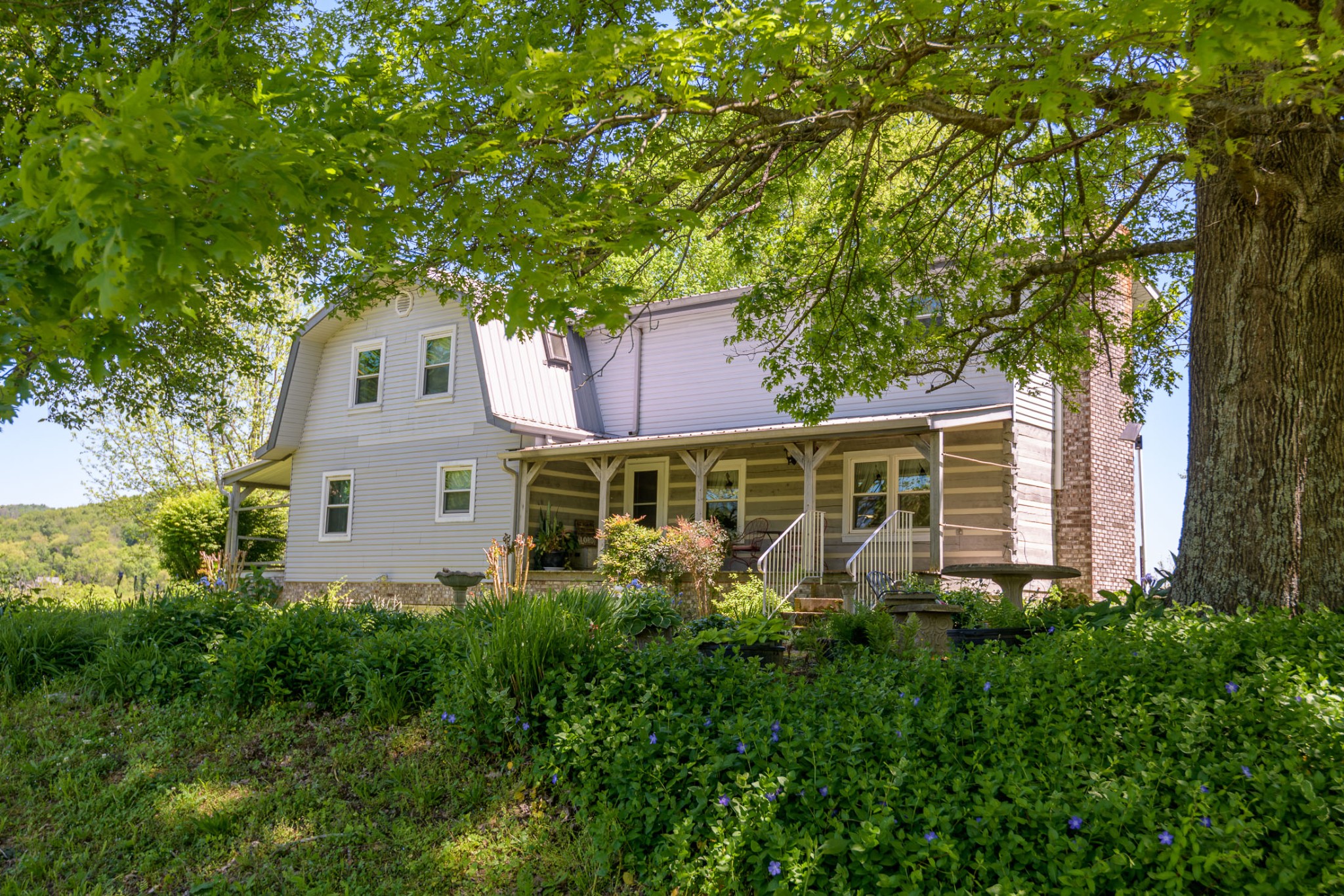 4496 Lower Helton Road Alexandria, TN 37012 - Photo 1 of 40 a house that has a tree in front of it