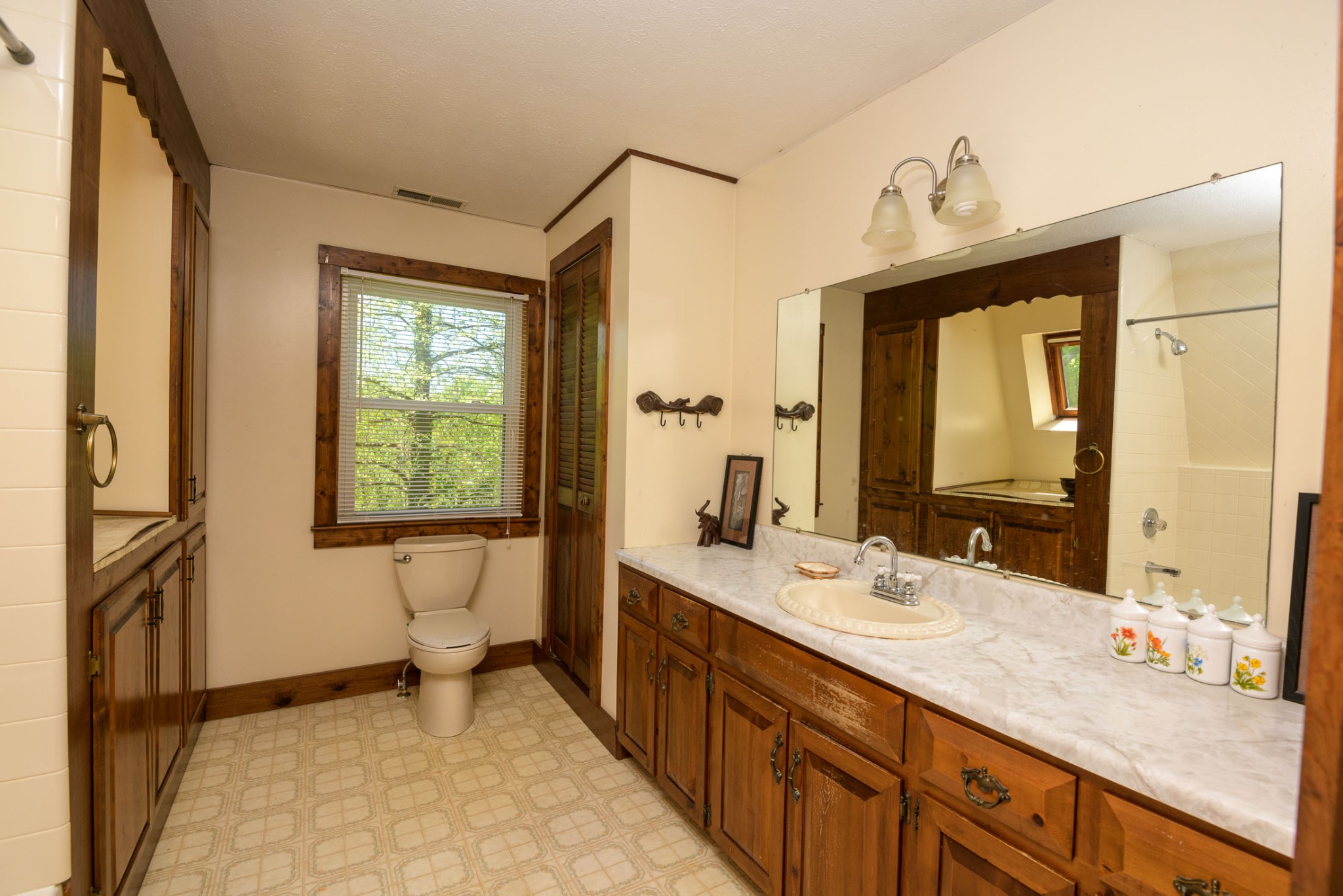 4496 Lower Helton Road Alexandria, TN 37012 - Photo 6 of 40 a bathroom with a granite countertop sink mirror and a bathtub