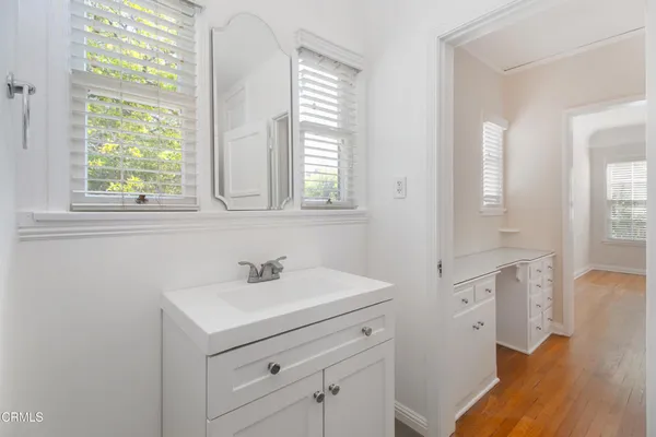a bathroom with 2 sink and a mirror