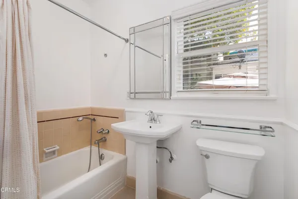 a bathroom with a sink a mirror and a bathtub
