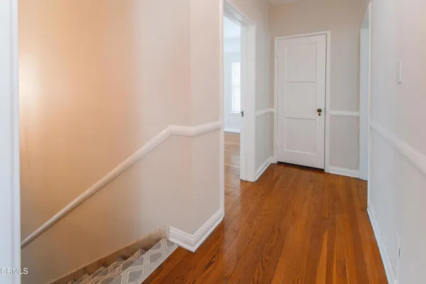 a view of small space with wooden floor and staircase