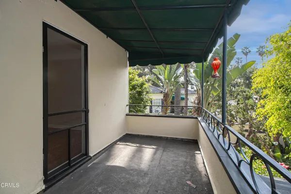 a view of a house with a small yard and wooden fence