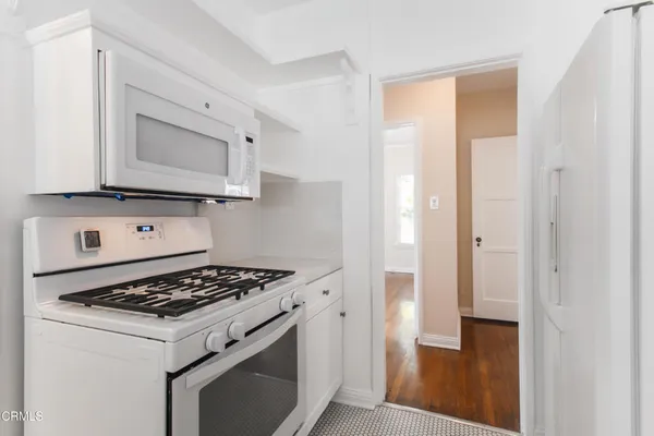 a kitchen with a stove and a microwave