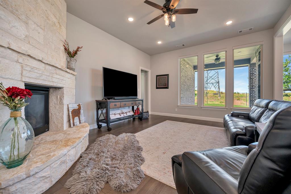 1129 Highpoint Way Roanoke, TX 76262 - Photo 11 of 26 a living room with furniture and a flat screen tv