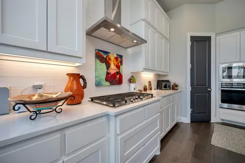 a kitchen with stainless steel appliances granite countertop a stove and a refrigerator