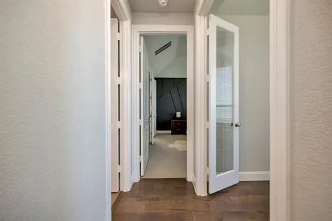 a view of a bathroom from a corridor
