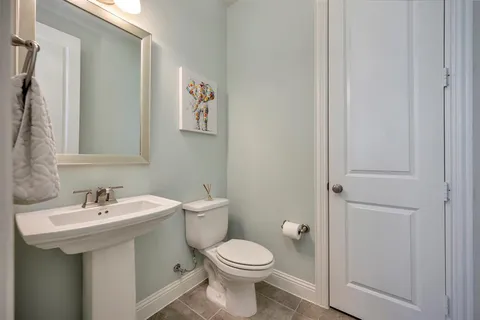 a bathroom with a sink toilet and a mirror