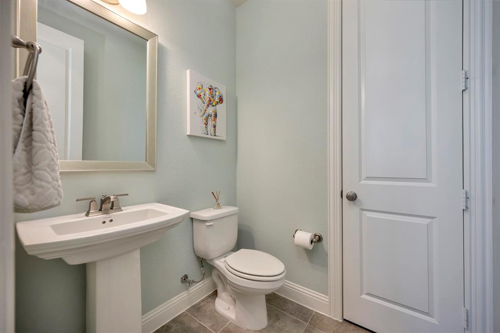 1129 Highpoint Way Roanoke, TX 76262 - Photo 17 of 26 a bathroom with a sink toilet and a mirror