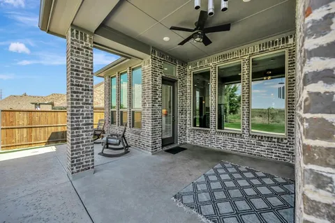 a view of a house with a garden and patio
