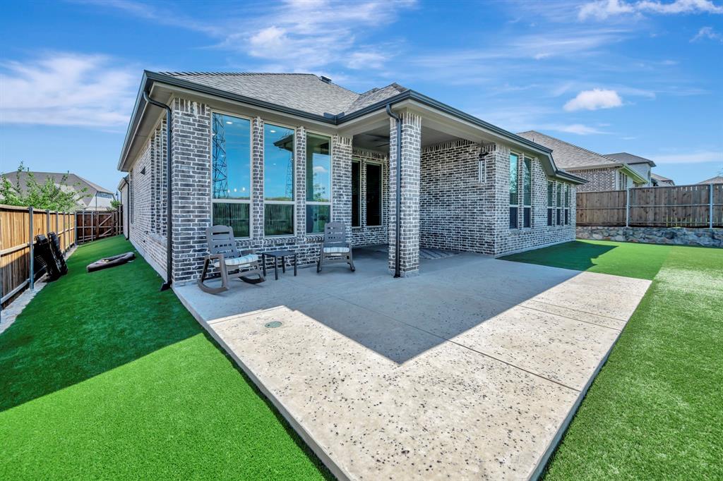 1129 Highpoint Way Roanoke, TX 76262 - Photo 23 of 26 a front view of a house with garden
