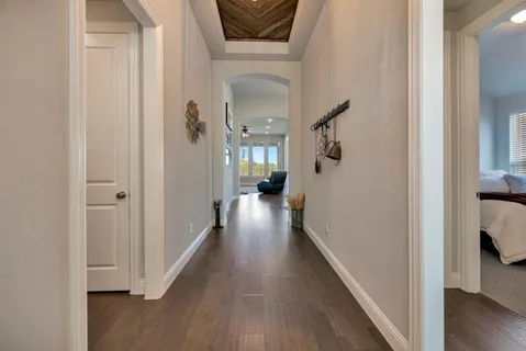 a view of hallway with wooden floor