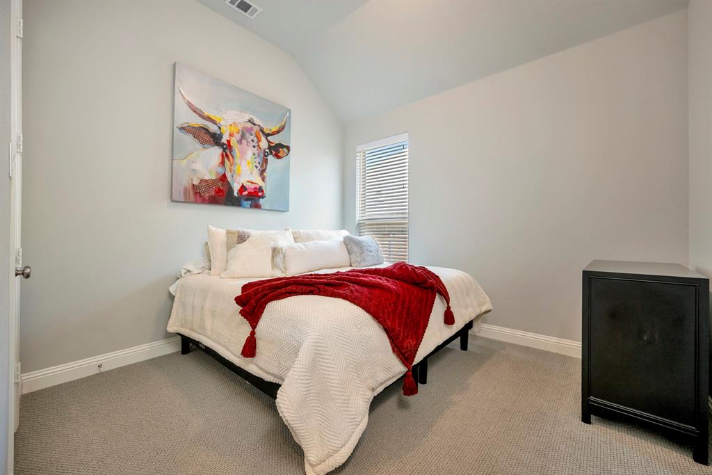 1129 Highpoint Way Roanoke, TX 76262 - Photo 5 of 26 a bedroom with a bed and a painting on the wall