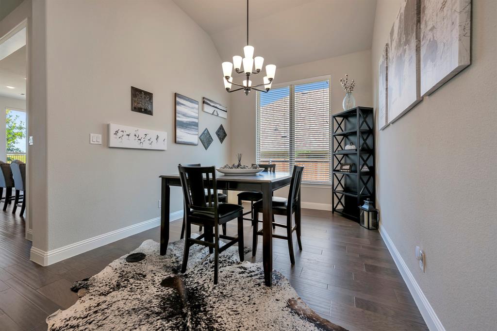 1129 Highpoint Way Roanoke, TX 76262 - Photo 8 of 26 a view of a dining room with furniture and chandelier