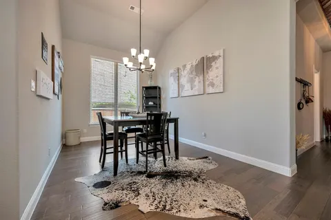 a view of a dining room with furniture and chandelier