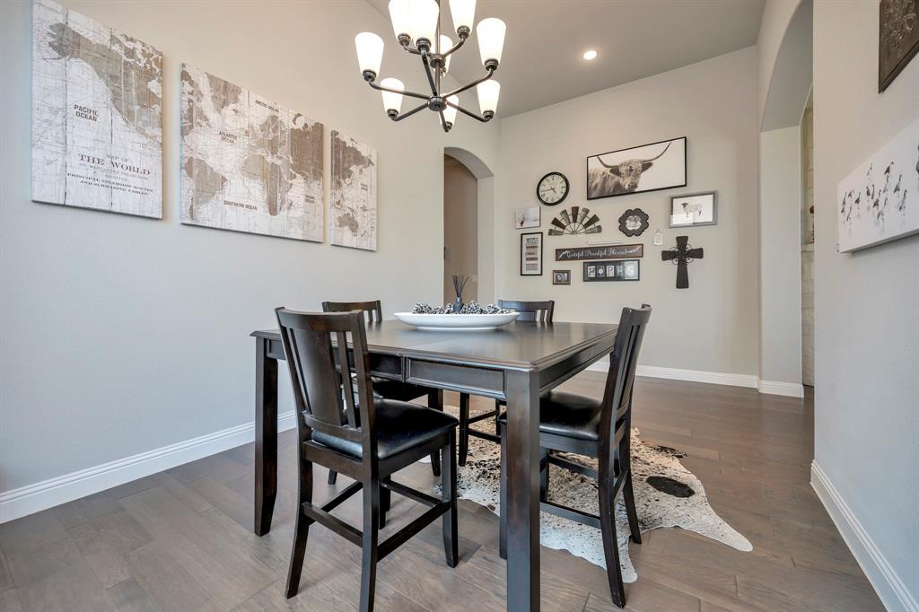 1129 Highpoint Way Roanoke, TX 76262 - Photo 9 of 26 a view of a dining room with furniture and wooden floor