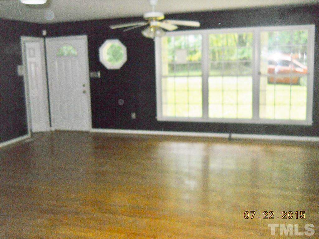 12201 North Roxboro Street Rougemont, NC 27572 - Photo 3 of 10 a view of an empty room with a window and wooden floor