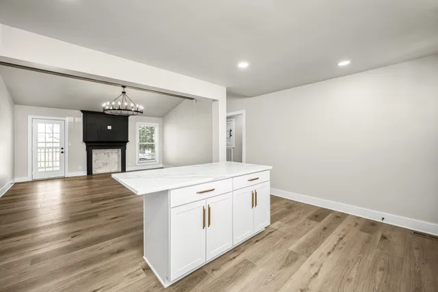 a kitchen with a wooden floor and stove