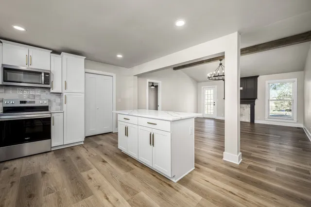 a kitchen with stainless steel appliances a stove top oven and refrigerator