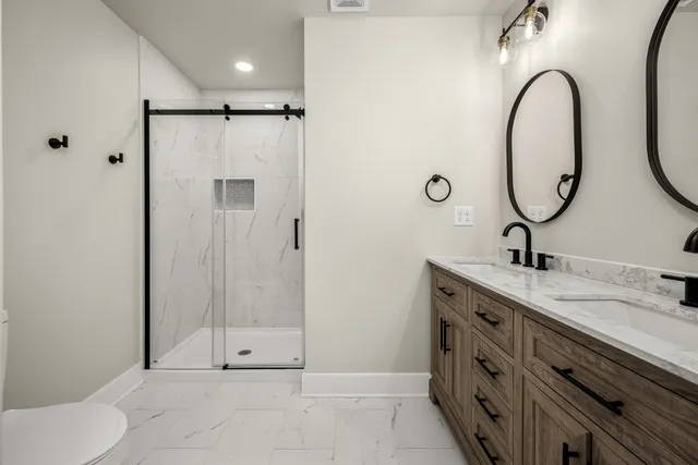 a bathroom with a sink a toilet and a mirror