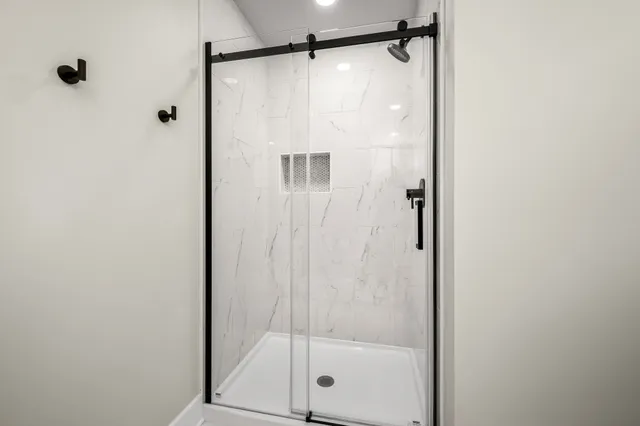 a bathroom with a glass shower door