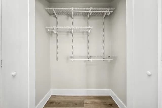 a view of walk in closet with empty racks