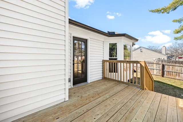 a view of a house with wooden deck